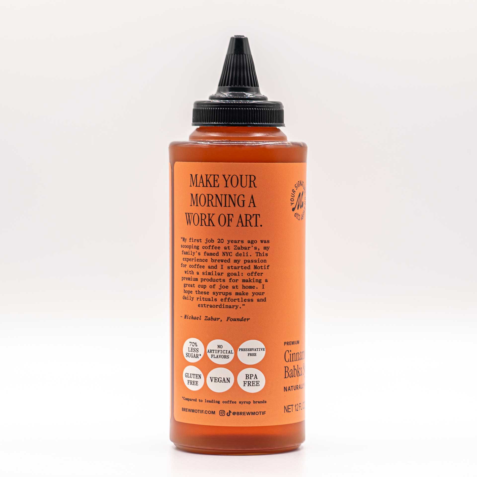 Side view of the bottle featuring the "Make Your Morning a Work of Art" quote and dietary badges.