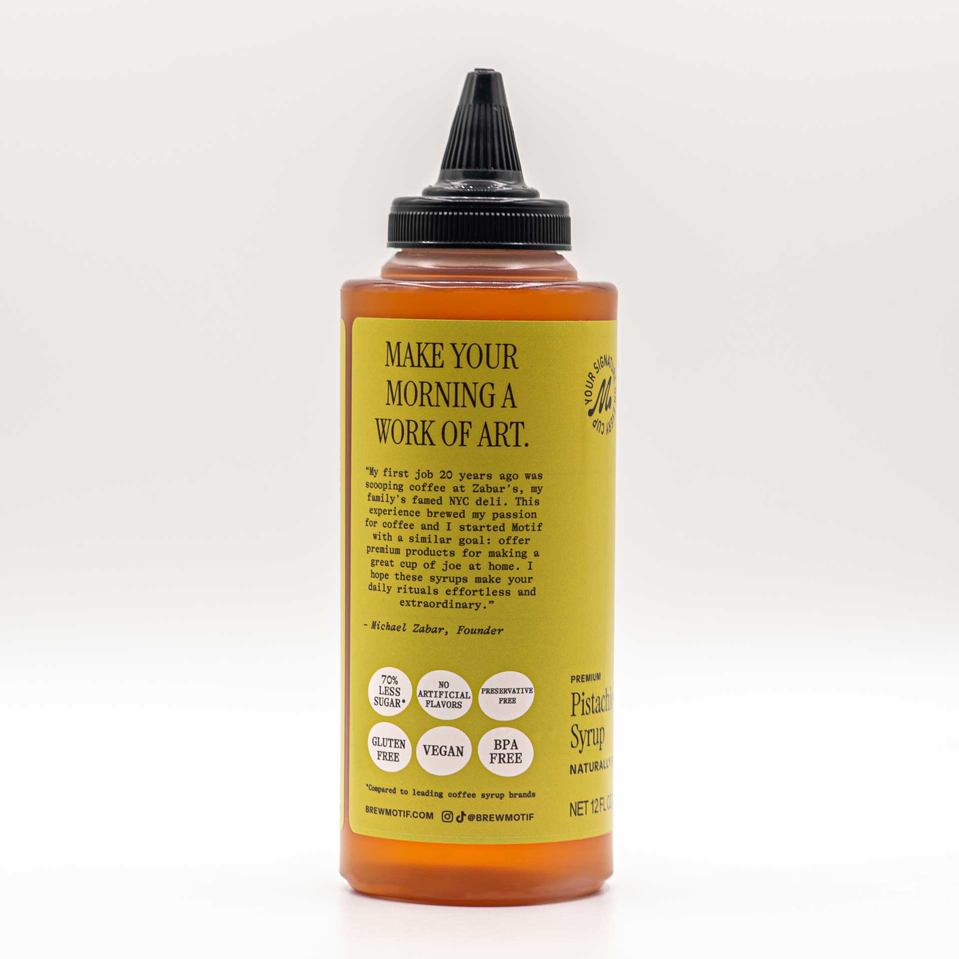 Side view of the bottle featuring the "Make Your Morning a Work of Art" quote and dietary badges.