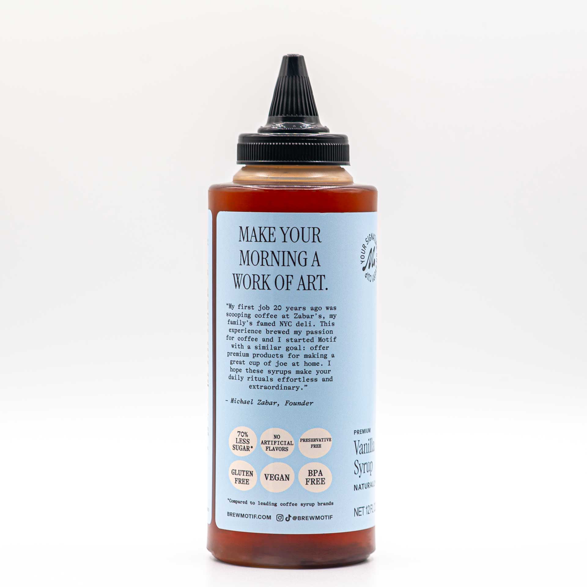 Side view of the bottle featuring the "Make Your Morning a Work of Art" quote and dietary badges.
