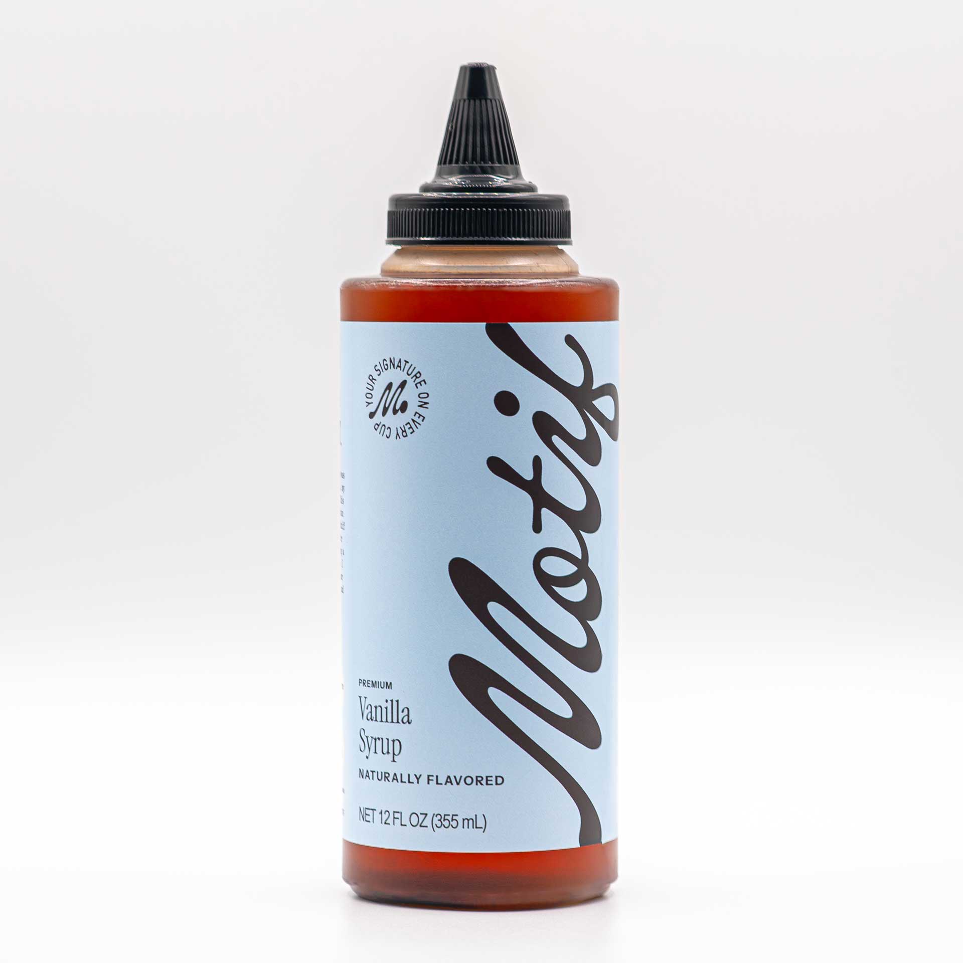 Bottle of Motif Premium Vanilla Syrup with a light blue label and black twist precision cap.