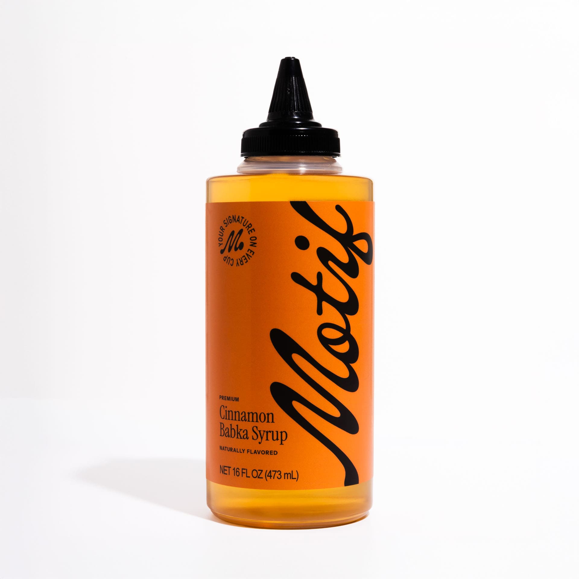 Bottle of Motif Premium Cinnamon Babka Syrup with an orange label and black twist precision cap.
